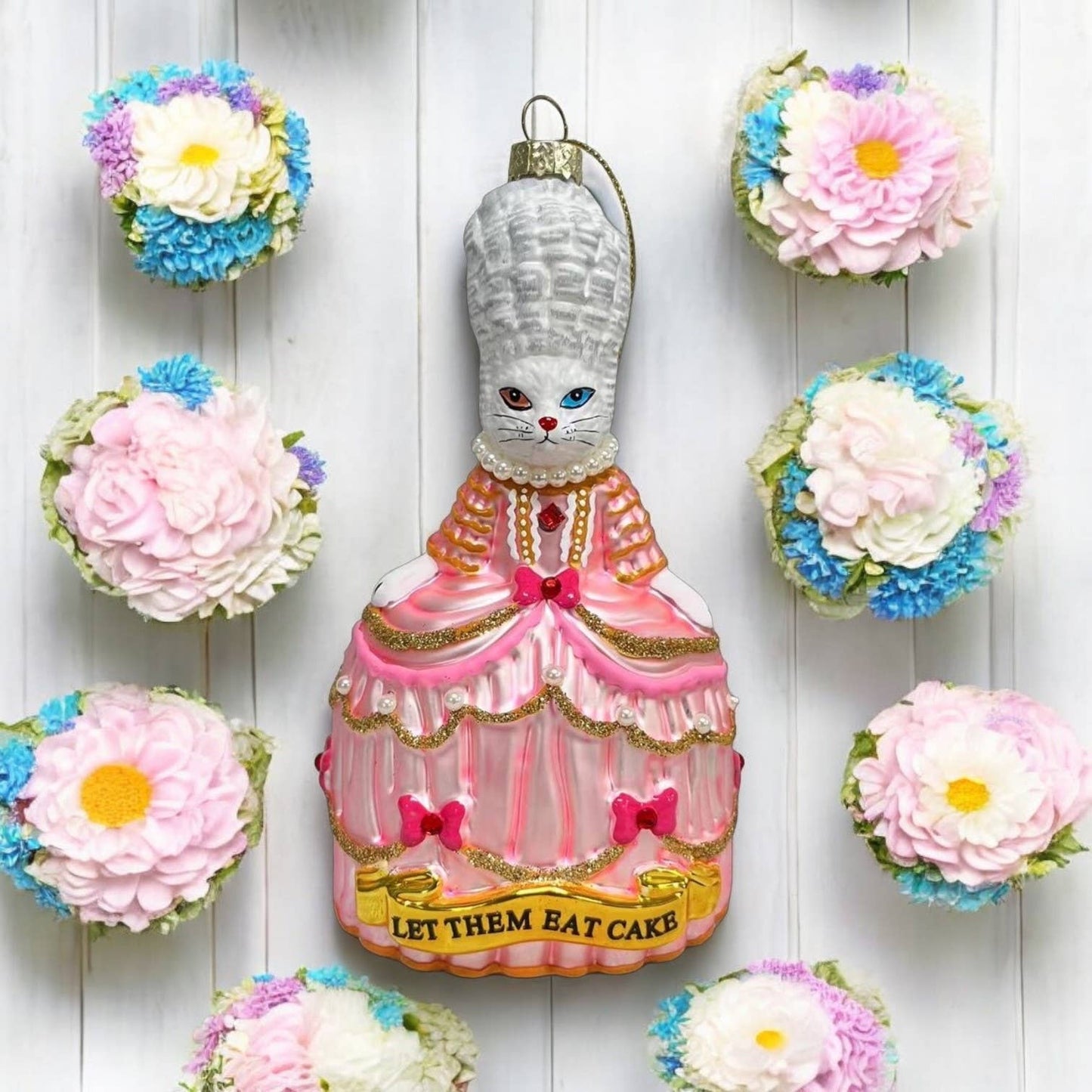 Christmas bauble featuring a white cat named Marie Antoinette, “Let Them Eat”